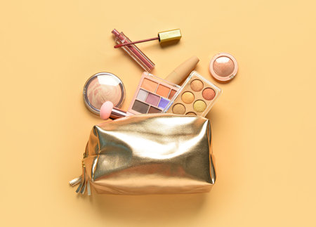 Bag with different decorative cosmetics on orange backgroundの写真素材