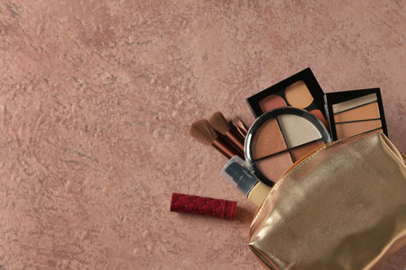 Bag with decorative cosmetic products on grunge brown backgroundの写真素材