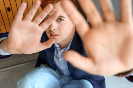 Fearful young businessman in office, closeupの写真素材