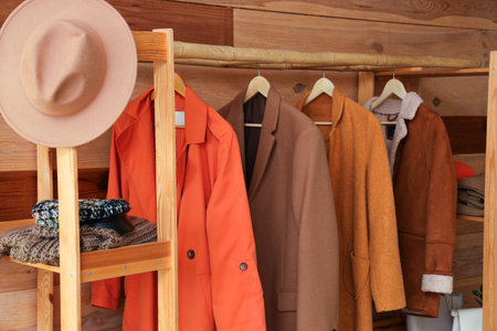 Rack with stylish autumn clothes in interior of modern hallwayの写真素材