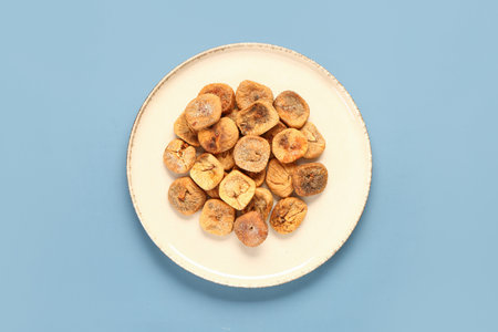 Plate with sweet dried figs on blue backgroundの写真素材