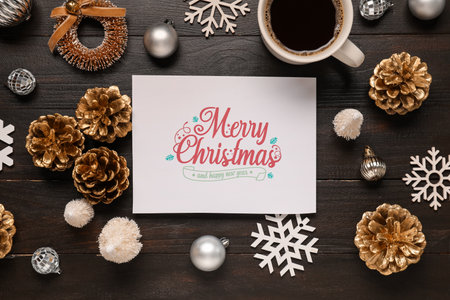 Beautiful Christmas composition with greeting card, decor and cup of coffee on black wooden backgroundの写真素材