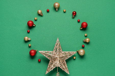 Frame made of Christmas balls and star on green backgroundの写真素材