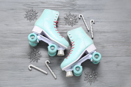 Composition with vintage roller skates and Christmas decorations on gray wooden backgroundの写真素材