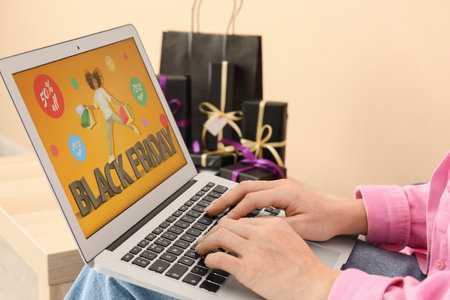 Woman with laptop shopping online on Black Friday at homeの写真素材