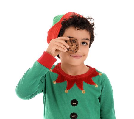 Cute little boy in elf costume with tasty cookie isolated on white backgroundの写真素材