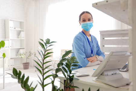 Female medical intern at reception in clinicの写真素材