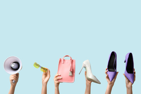 Female hands with women accessories and megaphone on blue background. Black Friday saleの写真素材