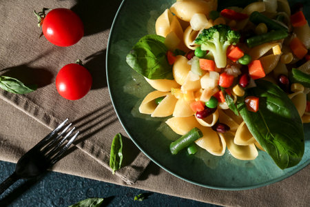 Plate with tasty pasta primavera on tableの写真素材