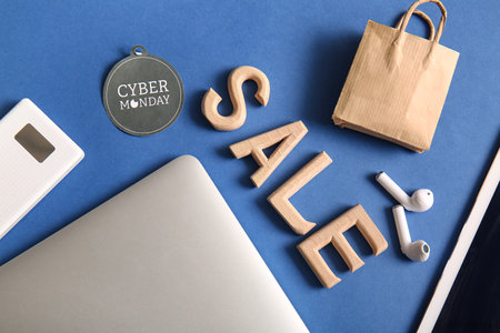 Word SALE made of wooden letters and gadgets on blue background. Cyber Mondayの写真素材