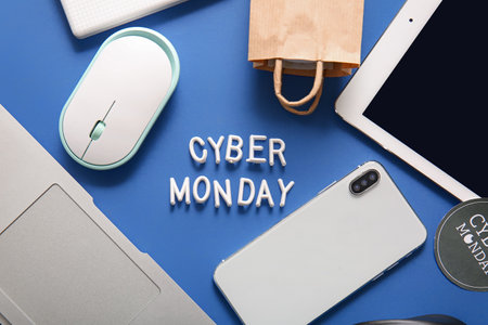 Text CYBER MONDAY made of letters and gadgets on color backgroundの写真素材
