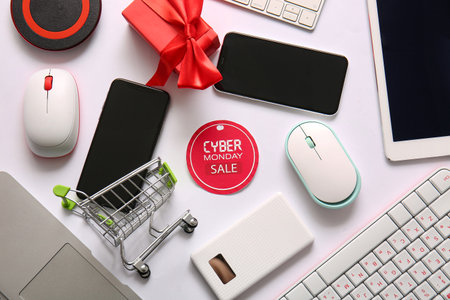 Shopping tag with text CYBER MONDAY SALE and gadgets on light backgroundの写真素材