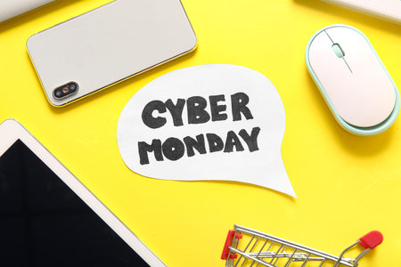 Speech bubble with text CYBER MONDAY and gadgets on yellow background