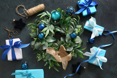 Christmas mistletoe wreath with balls and gift boxes on dark backgroundの写真素材
