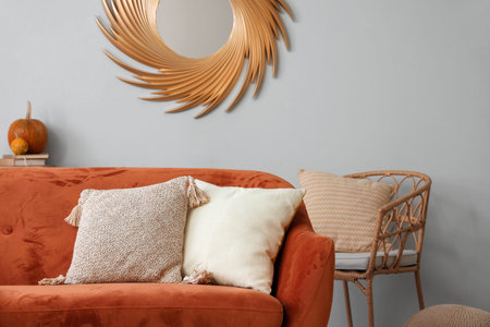 Red sofa with cushions in living roomの写真素材