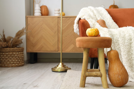 Stool with pumpkins in living roomの写真素材