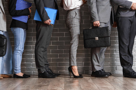 Business people waiting for their turn in office hallの写真素材