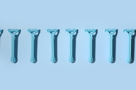 Many safety razors on blue backgroundの写真素材