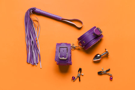 Different purple sex toys on orange backgroundの写真素材