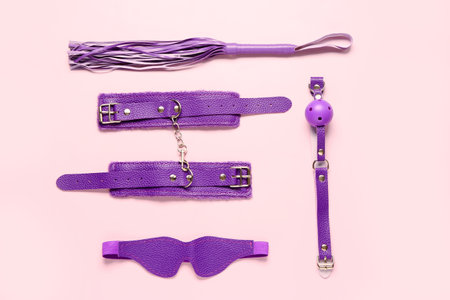 Different purple sex toys on pink backgroundの写真素材