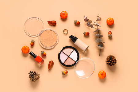 Composition with cosmetic products and autumn decor on beige backgroundの写真素材
