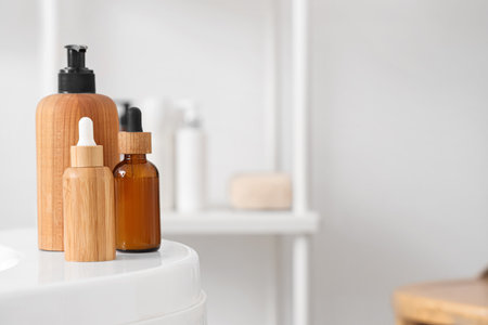 Cosmetic bottles on bathtub in room, closeupの写真素材