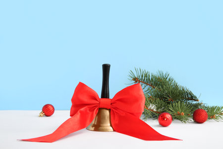 Christmas bell with fir branches and balls on colorful backgroundの写真素材