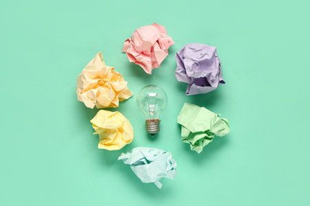 Crumpled paper and light bulb on green background. Business idea conceptの写真素材