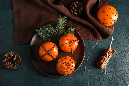 Plate with pomander balls and Christmas tree branches on dark backgroundの写真素材