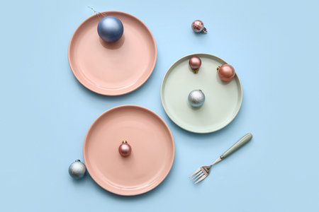 Beautiful table setting with Christmas balls on blue backgroundの写真素材