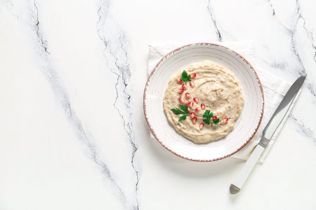 Plate of tasty baba ghanoush on white marble backgroundの写真素材