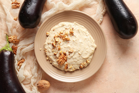 Plate of tasty baba ghanoush on beige backgroundの写真素材