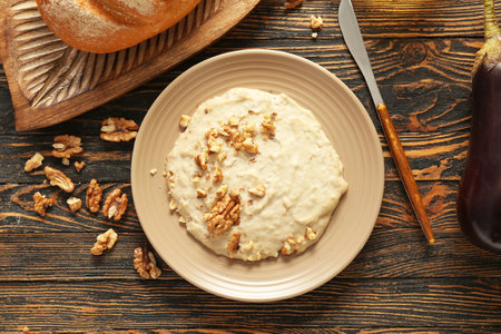 Plate of tasty baba ghanoush on wooden backgroundの写真素材