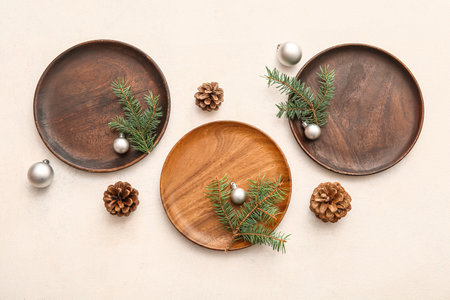 Beautiful table setting with Christmas balls, cones and fir branches on white backgroundの写真素材