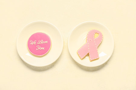 Pink cookies with text WE LOVE YOU and ribbon on light background. Breast cancer awareness conceptの写真素材