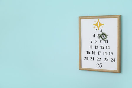 Christmas calendar on blue wallの写真素材