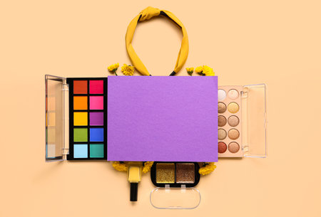 Composition with blank paper sheet, makeup products and beautiful flowers on beige backgroundの写真素材