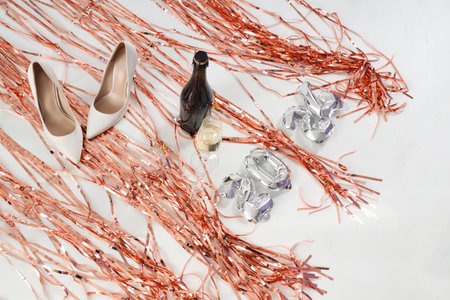 Figure 2024 with heels, champagne and tinsel on light backgroundの写真素材