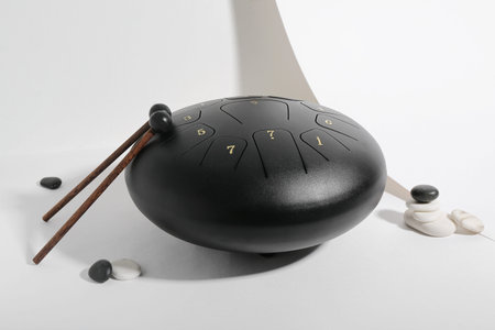 Glucophone with sticks and spa stones on gray background