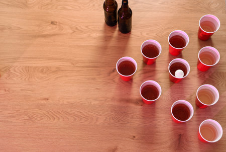 Cups for beer pong on table in room, top viewの写真素材