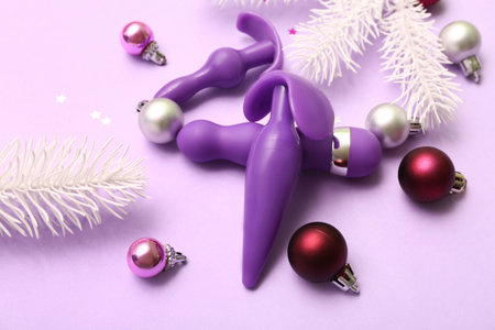 Purple sex toys and Christmas decor on lilac backgroundの写真素材