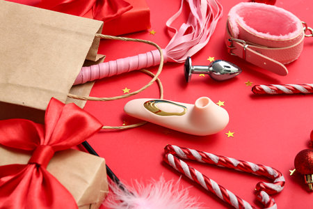 Shopping bag with sex toys and Christmas decor on red backgroundの写真素材