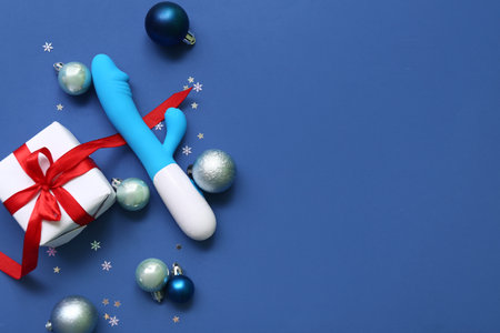 Vibrator with gift box and Christmas decor on blue backgroundの写真素材