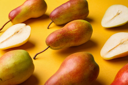 Ripe pears on yellow backgroundの写真素材
