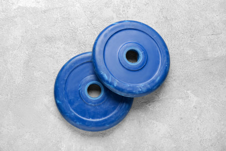 Barbell plates on gray backgroundの写真素材
