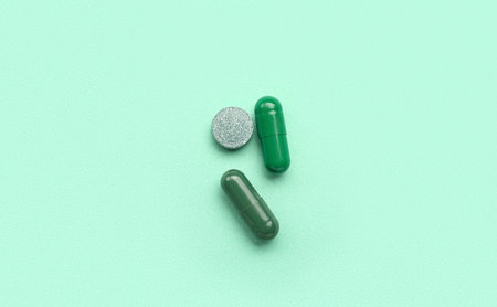 Different medical pills on turquoise background