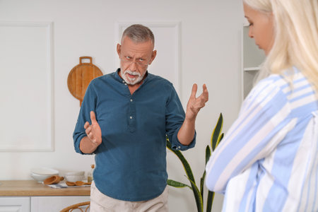 Mature couple quarreling in kitchen. Divorce conceptの写真素材