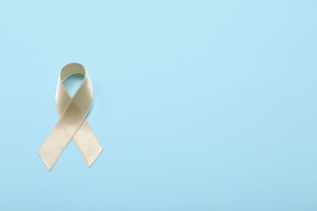 Beige ribbon on blue background. Uterine cancer awareness conceptの写真素材