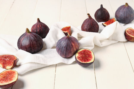 Fresh ripe figs on white wooden backgroundの写真素材