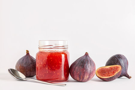 Jar of sweet fig jam on white backgroundの写真素材
